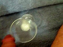 Solo cumshot captured in a glass after intense stroking