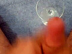 Solo cumshot captured in a glass after intense stroking