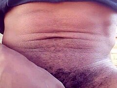 Moaning while stroking big black cock outdoors