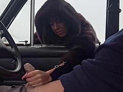 Public handjob in car with furcoat at outdoor lot