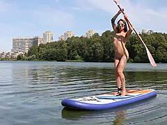 Petite brunette with shaved pussy walks naked on outdoor beach feeling exposed and free.
