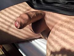 amateur guy strokes his big cock solo in bedroom close-up during hot summer