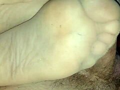 Amateur girlfriend teases with sensual footjob in tan stockings over leggings. She uses toes and feet for dirty homemade fetish play.