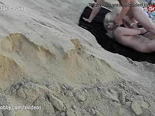 Cheeky blonde sucks cock on public beach