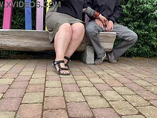 Stranger MILF jerks cock in public park