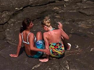 Hard lesbian fucking on rocks by the sea