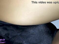 Transsexual in navy blue swimsuit gets coated with slippery lotion