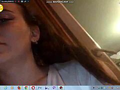 Sexy young brunette with big tits teases by showing boobs on webcam