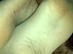 Amateur girlfriend teases with sensual footjob in tan stockings over leggings. She uses toes and feet for dirty homemade fetish play.