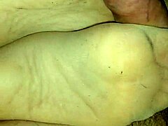 Amateur girlfriend teases with sensual footjob in tan stockings over leggings. She uses toes and feet for dirty homemade fetish play.