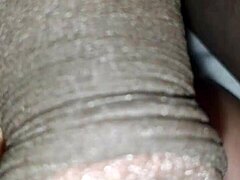 Man plays with huge black cock in big close-up view