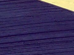 Pink princess struts on the beach with hidden candid vibes, contrasting her ass against the waves in intriguing princess style.