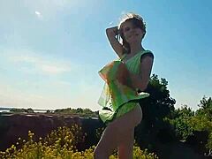 why don't you watch this spunky teen model strip naked outdoors, showing off her cute tits?