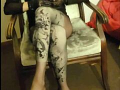 Crossdresser Maria struts in sheer black nylon pantyhose high heels miniskirt